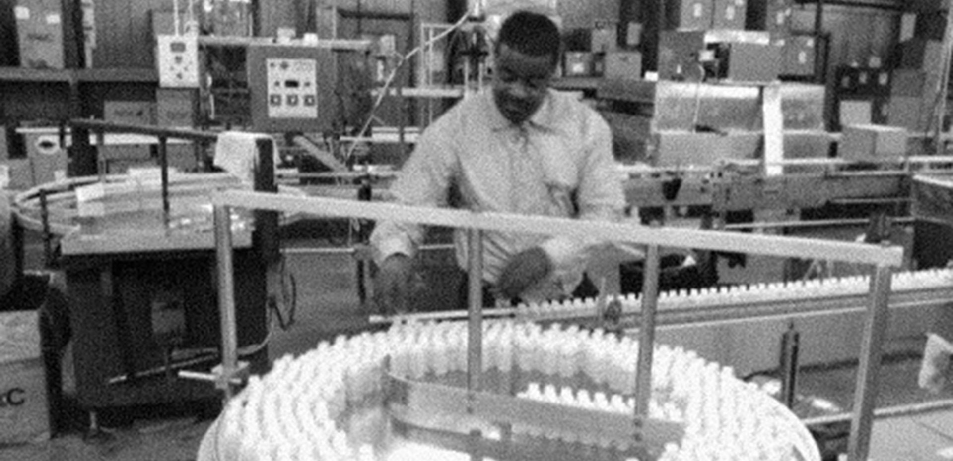 black and white photo of an African American man working in a factory