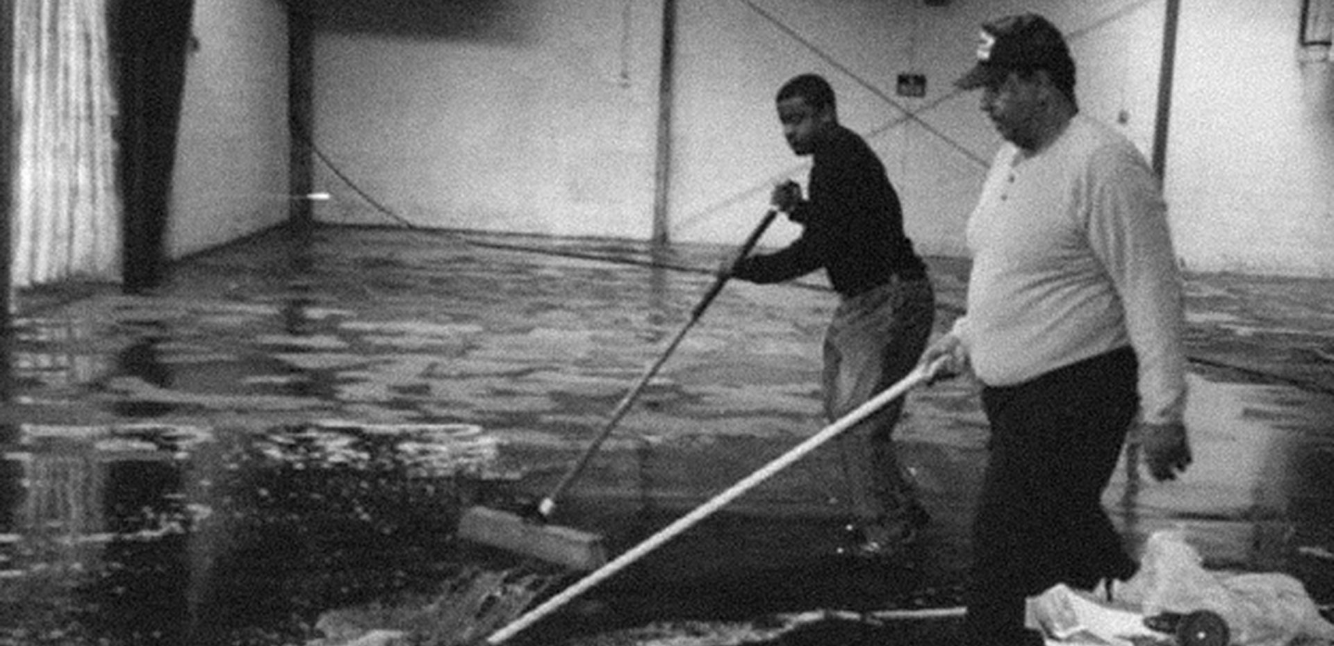 Black and white photo of African American men mopping