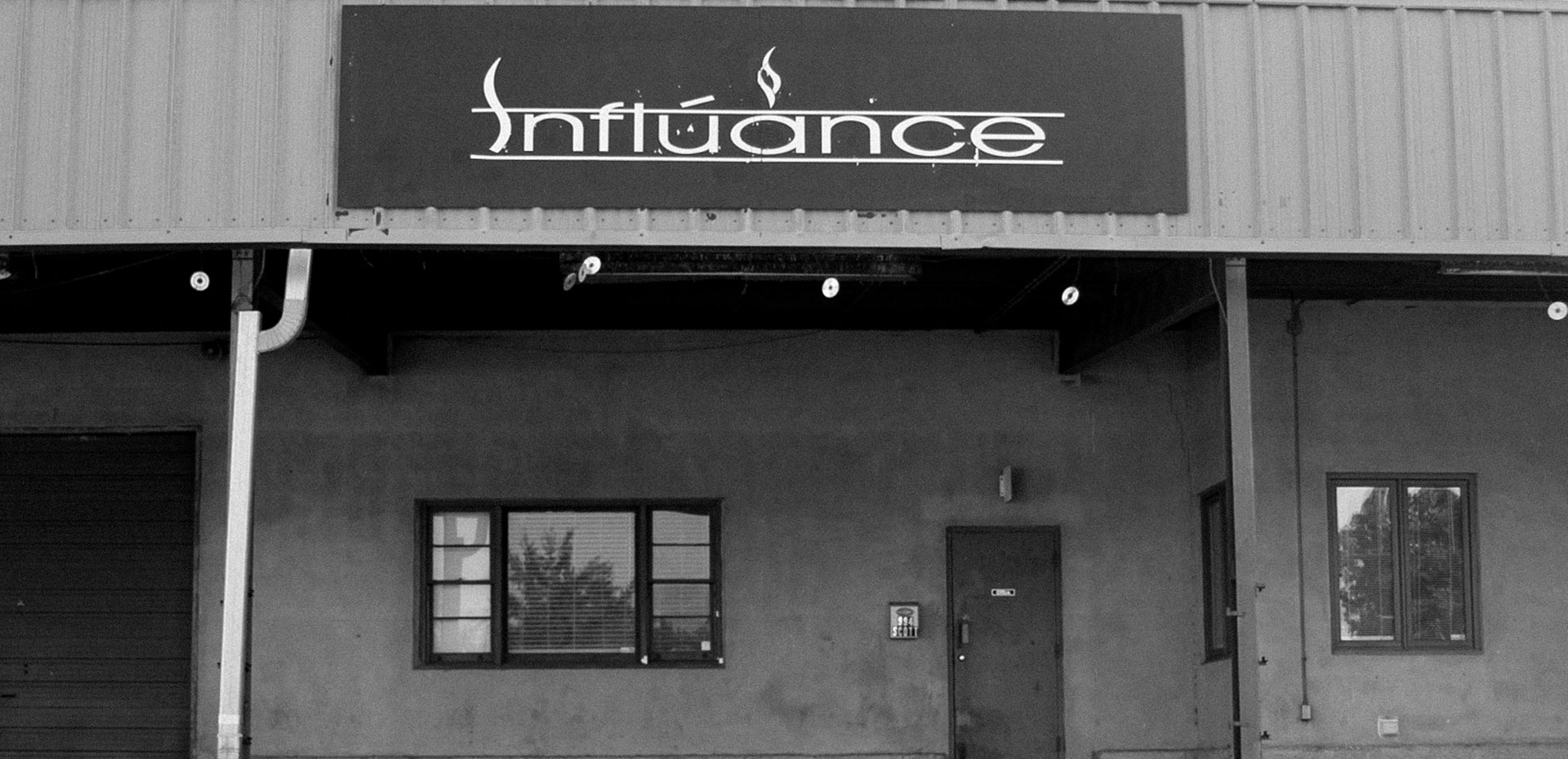 Black and white photo of Influance building sign